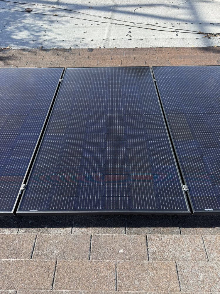 NFG Solar Panel Cleaning Company—Three solar panels are sitting on top of a brick walkway