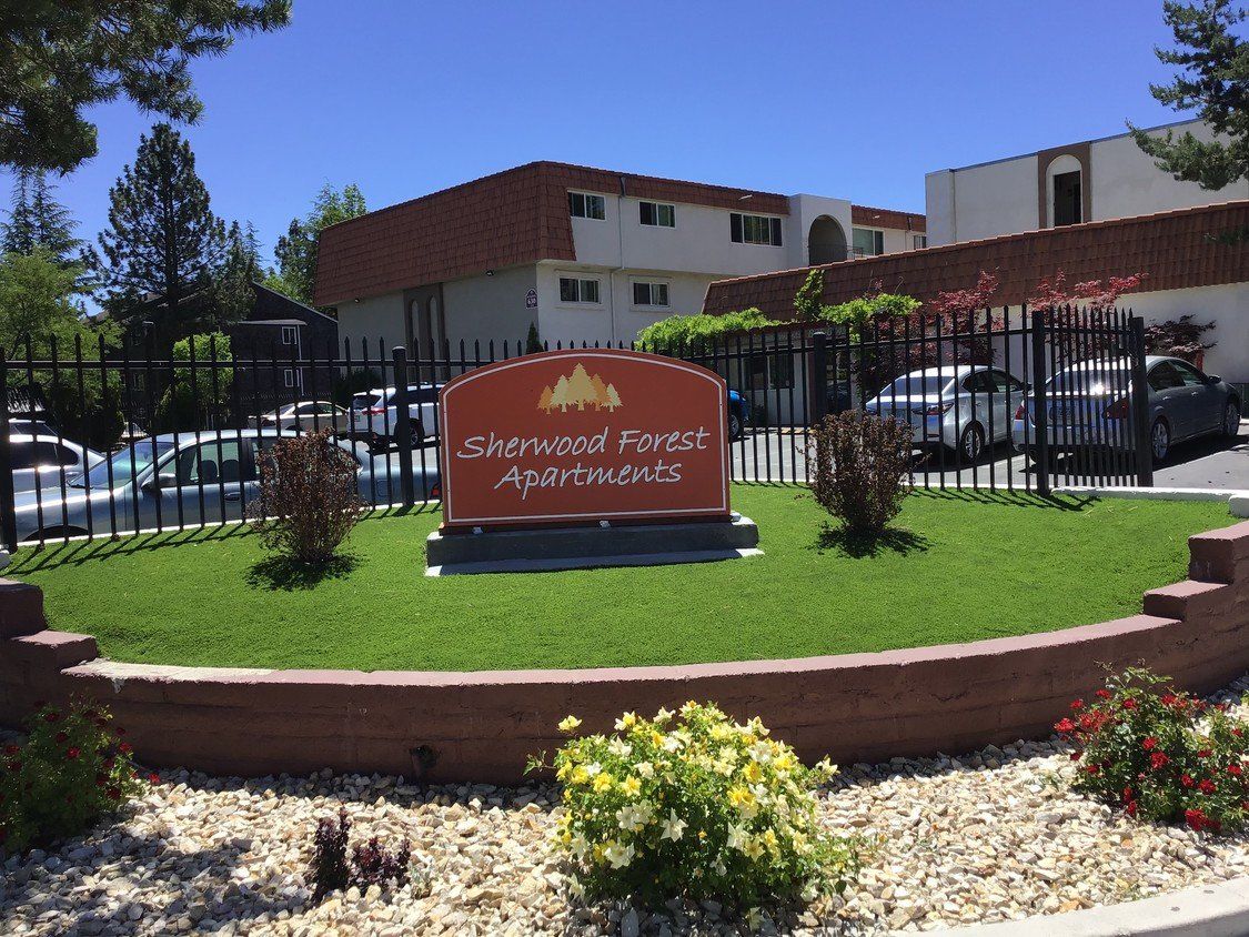 Exterior of Sherwood Forest Apartments with gated entrance in Reno, NV