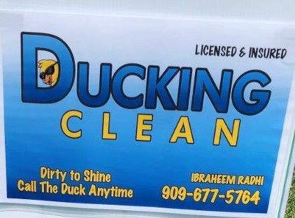 Blue ad for Ducking Clean with duck logo, licensed and insured, phone number, and “Dirty to Shine” slogan