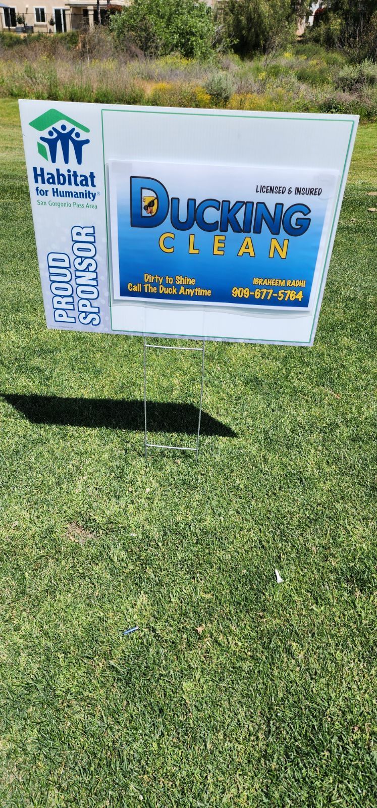 Habitat for Humanity sign on a grassy lawn advertising Ducking Clean