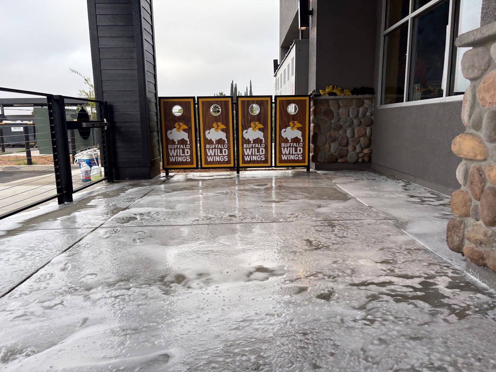 Icy sidewalk beside a building entrance with decorative gates and stone walls