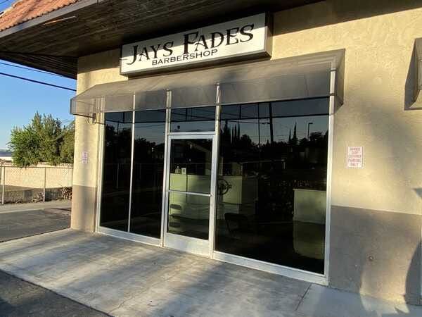 Storefront with glass doors and a sign reading “Jays Fades” above the entrance.