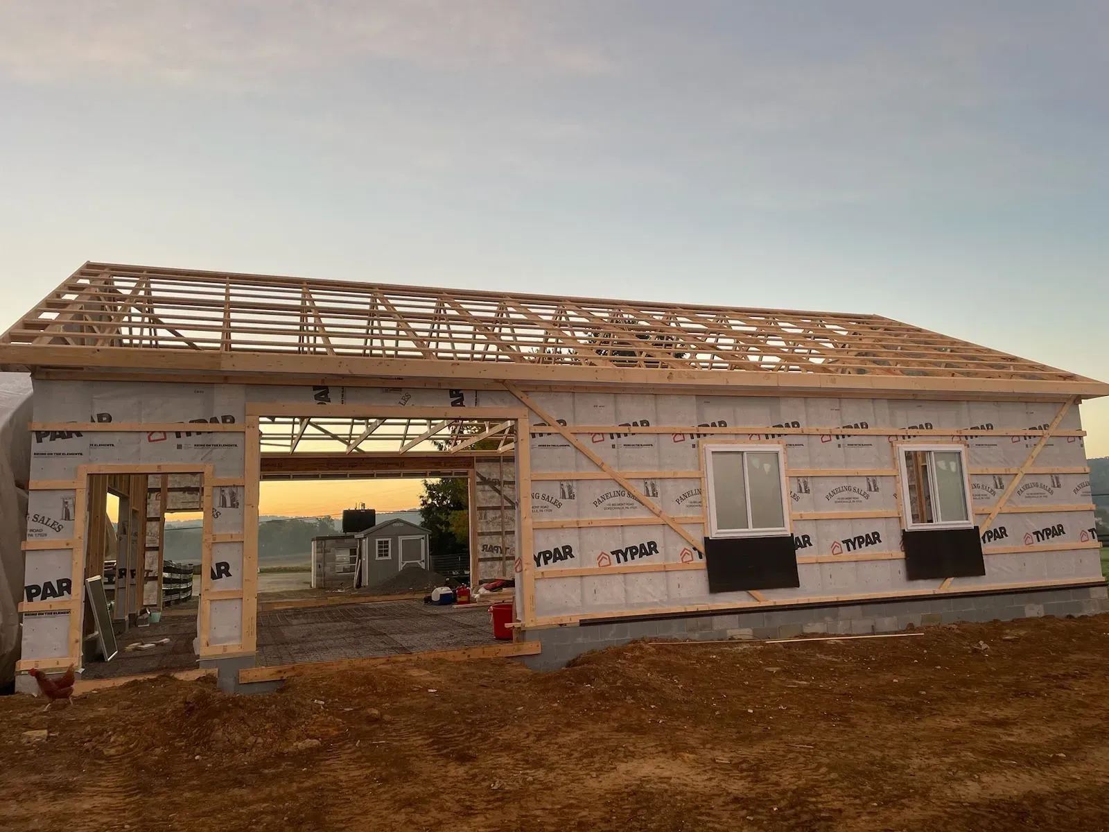 View of a barn being remodeled with no roof yet or siding