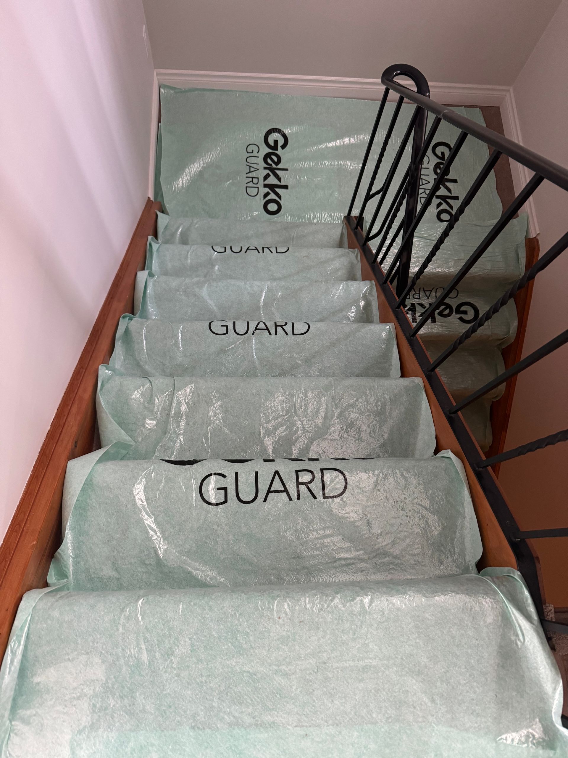 Staircase covered with green protective material, labeled