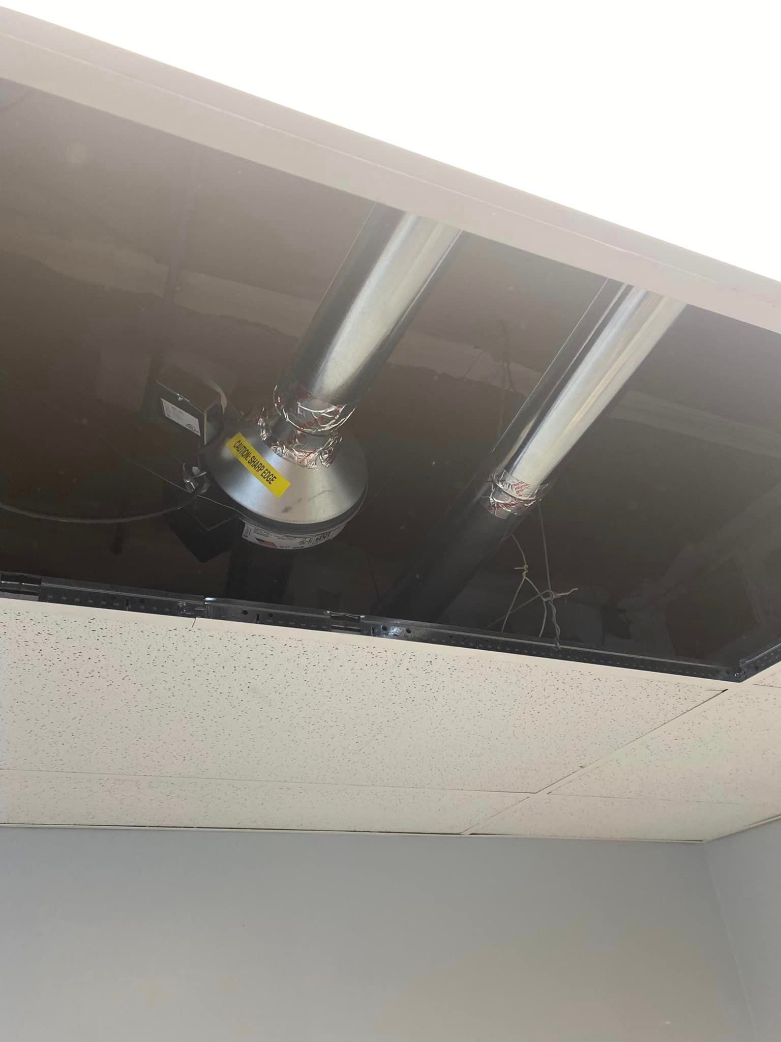 A close up of a ceiling with two lights coming out of it.