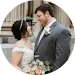 A bride and groom are looking at each other in a circle.