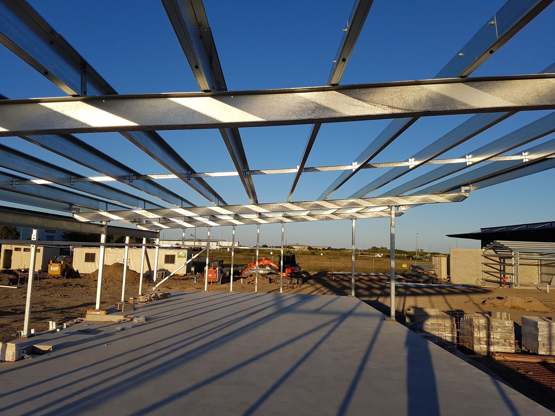 Steel framework under construction; clear blue sky above — Statewide Lift & Shift Pty Ltd In Paget, QLD
