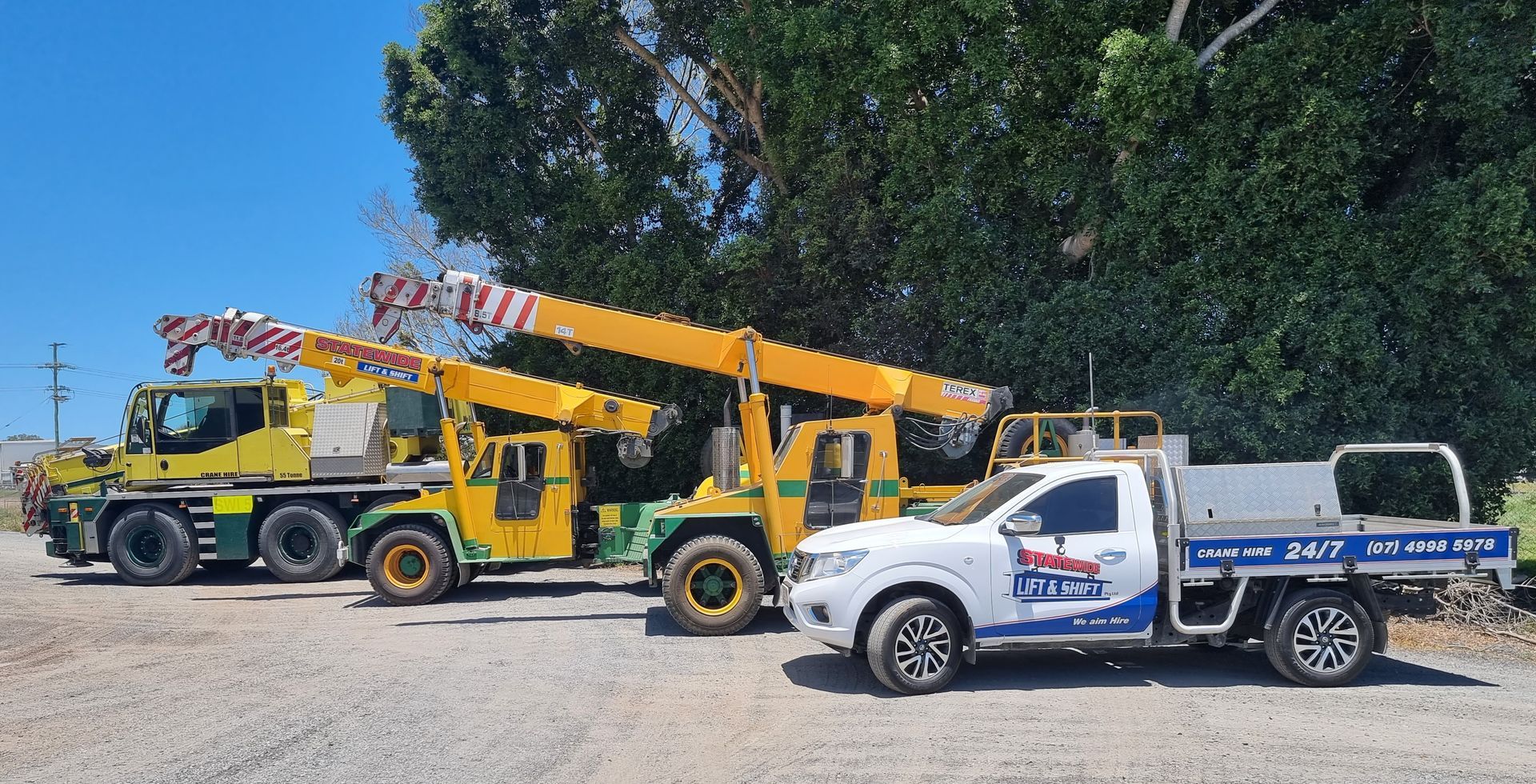Three Yellow Cranes and a White Service Truck Parked Outdoors — Statewide Lift & Shift Pty Ltd In Paget, QLD