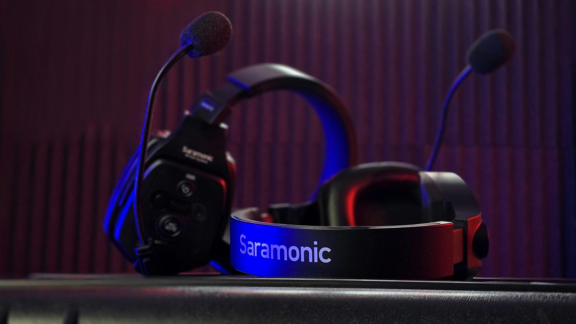 A pair of headphones with a microphone on top of a keyboard.