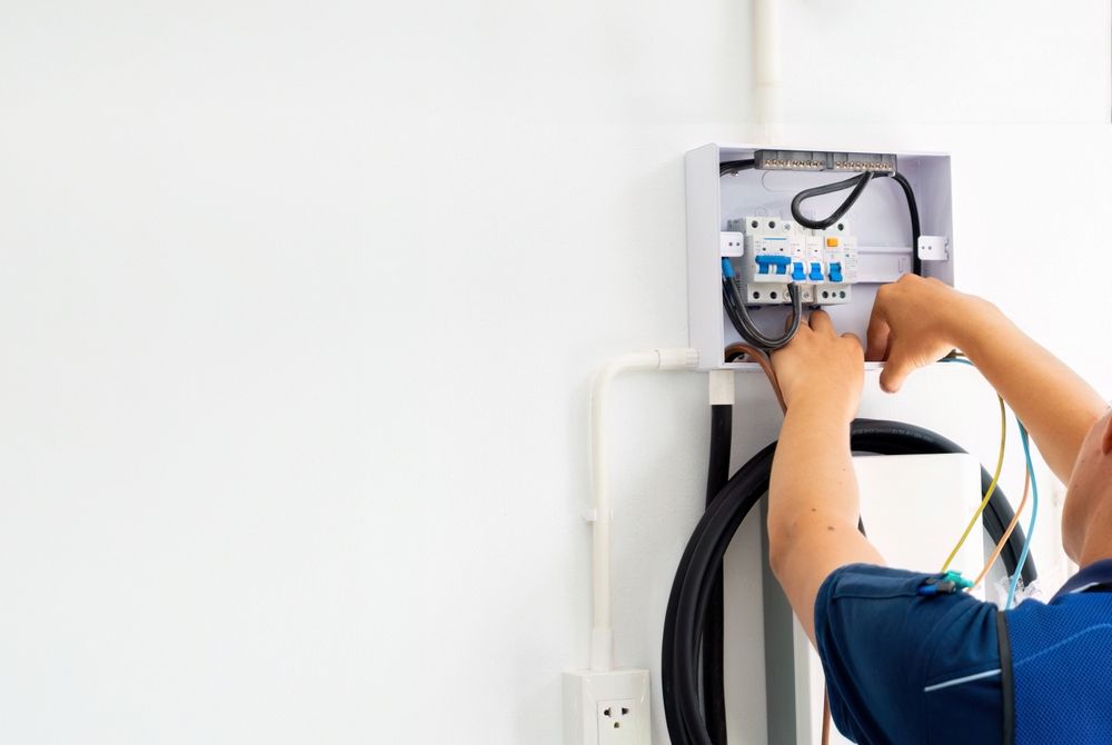 Electrician Working on Electrical Panel, Outdoors — White Rose Electrical in Coffs Harbour, NSW