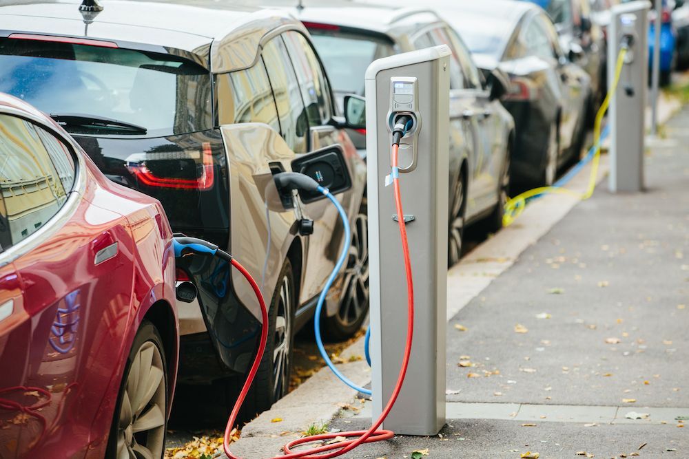Electric Vehicles Charging in a Row Alongside a Curb — White Rose Electrical in Coffs Harbour, NSW