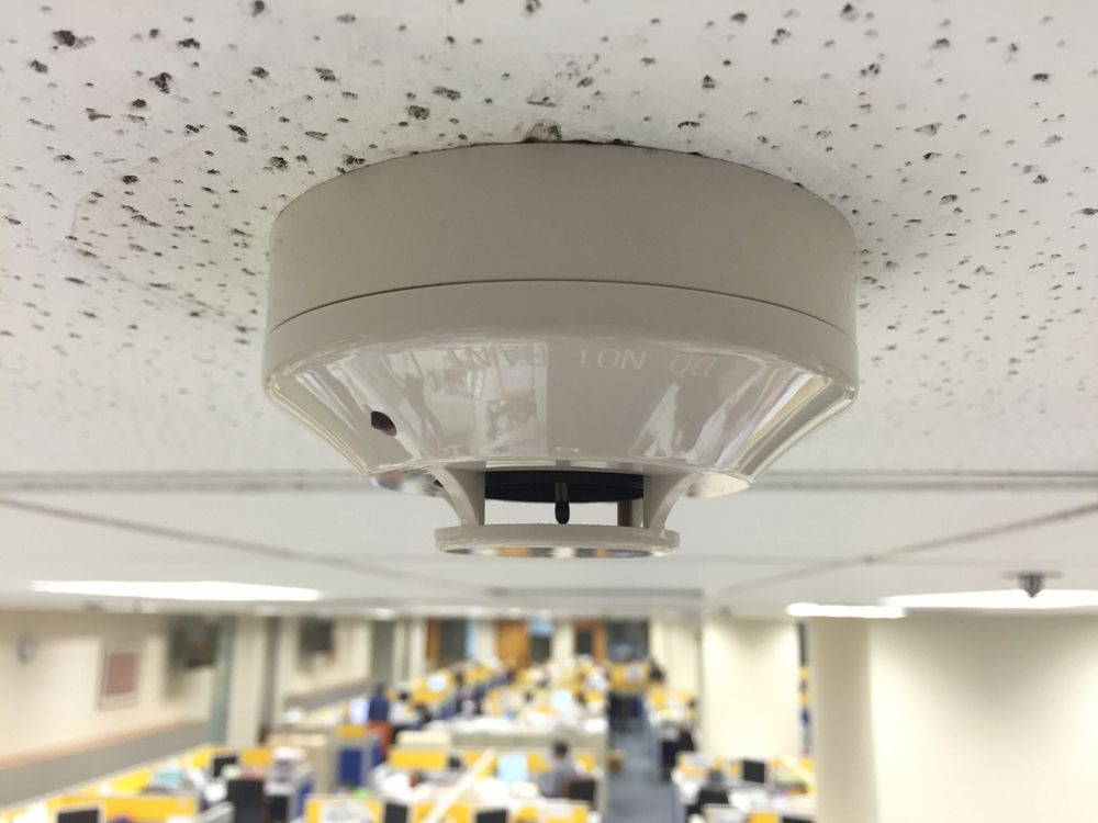 Smoke Detector on a Textured, Off-white Ceiling — White Rose Electrical in Coffs Harbour, NSW