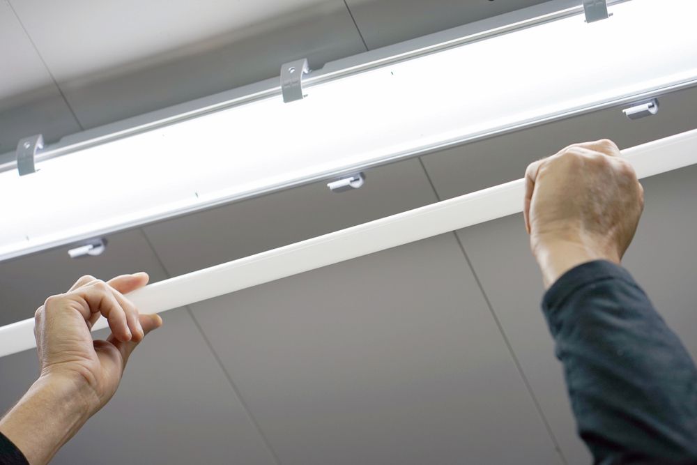 White Fluorescent Light Tube Near Other Mounted Lights on a Ceiling — White Rose Electrical in Coffs Harbour, NSW