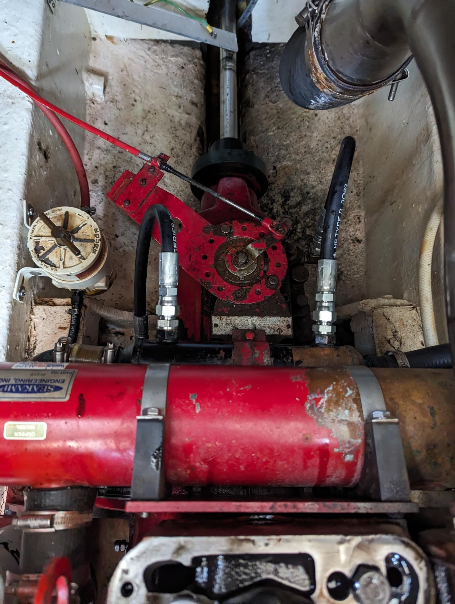 Red Hydraulic Pump and Components Inside a Boat's Engine Compartment — Symbiote Systems in Airlie Beach, QLD