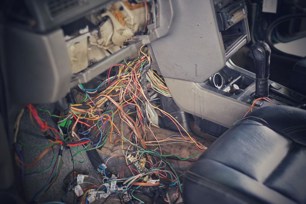 Tangled Wires Exposed Inside a Car Dashboard — Symbiote Systems in Airlie Beach, QLD