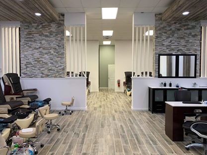 A nail salon with a lot of chairs and tables.