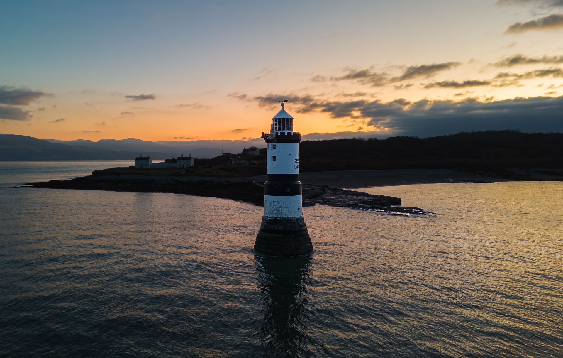 drone photography of a light house with sunset skyline 