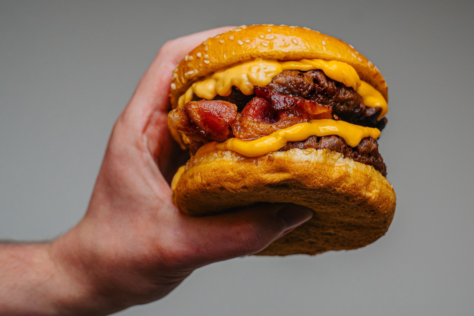 hand holding burger for marketing purposes