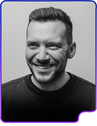 black and white headshot of man smiling