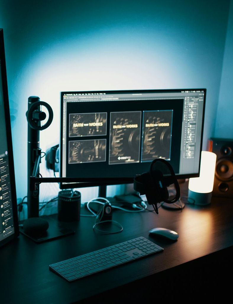 computer with blue neon light and editing software