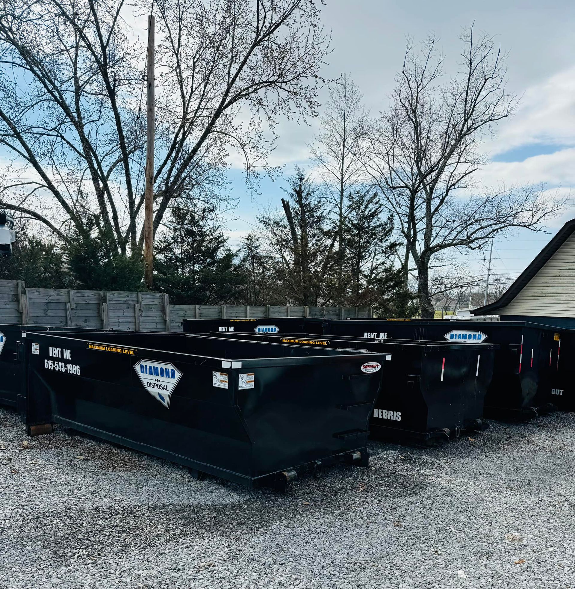 A row of black dumpsters labeled