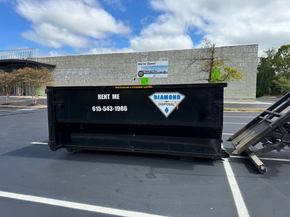 A black dumpster with 