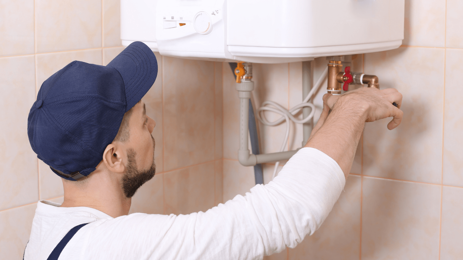Man fixing a water heater at a rental property