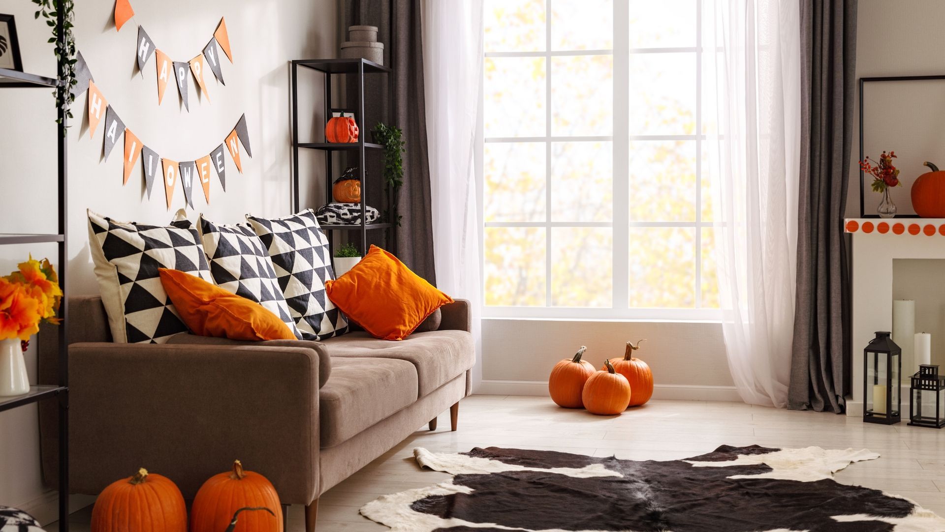 Cozy Halloween living room with pumpkins, orange and black cushions, 