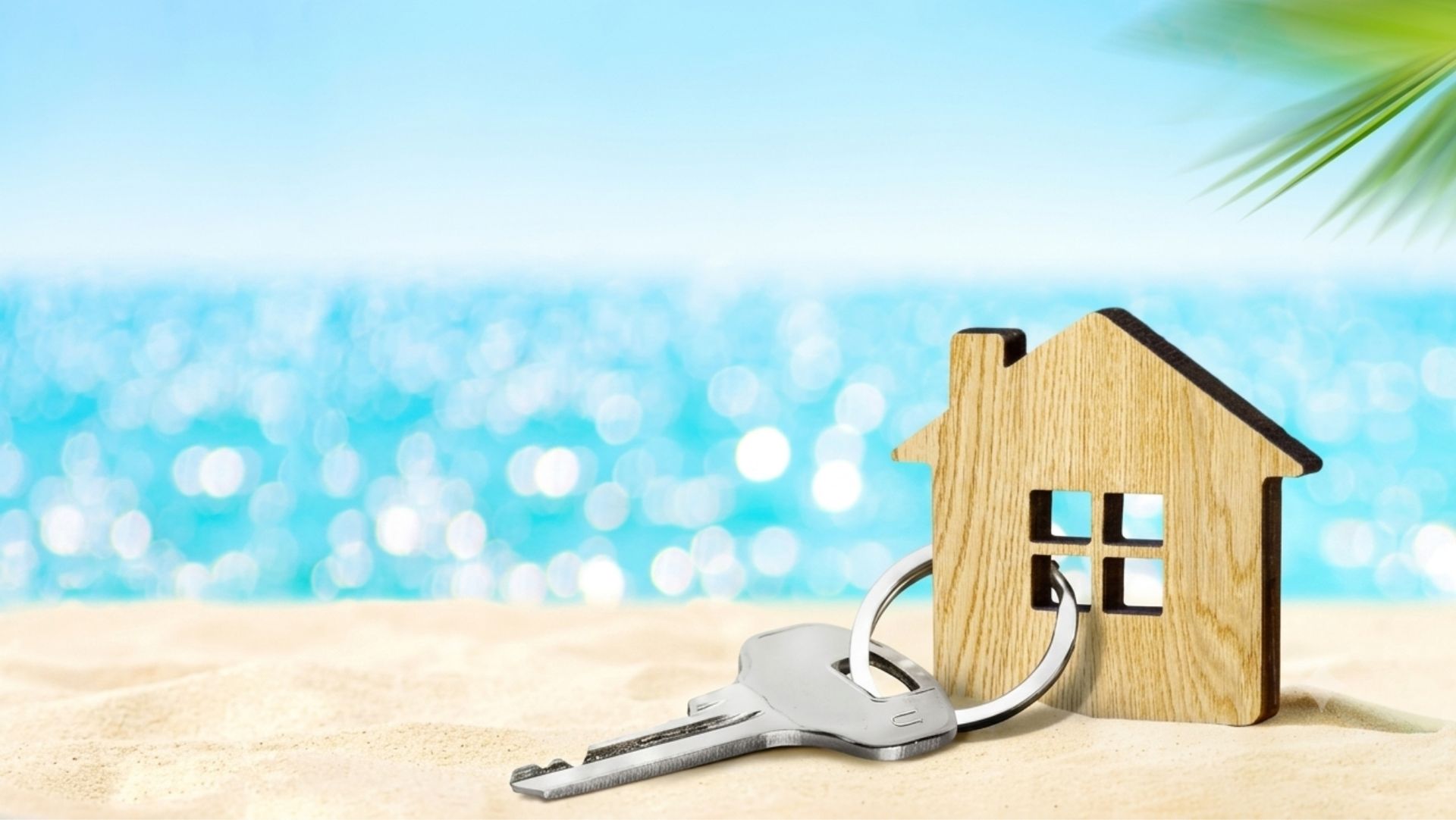 Redding CA rental housing market update with keys and miniature house on a beach
