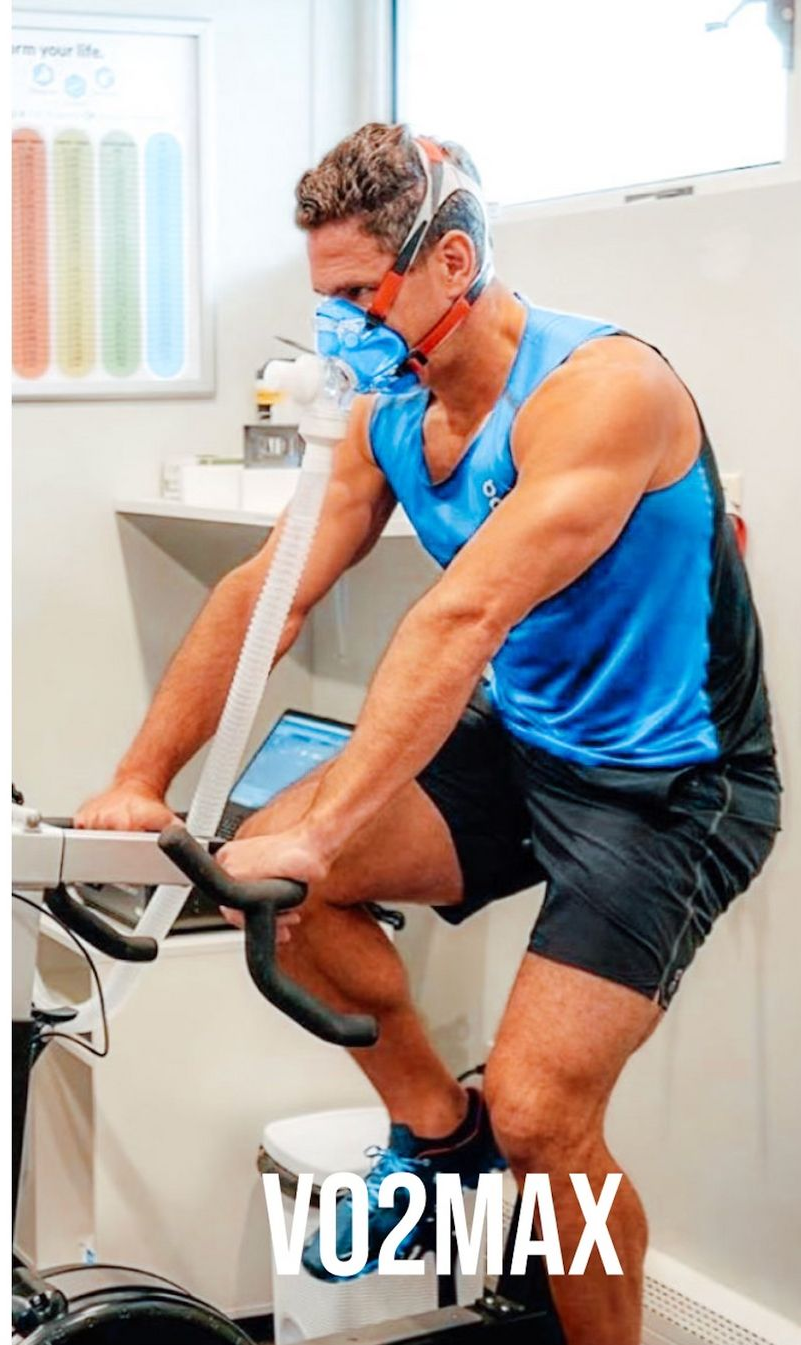 stationary bike, wearing a mask, likely for a VO2 max test