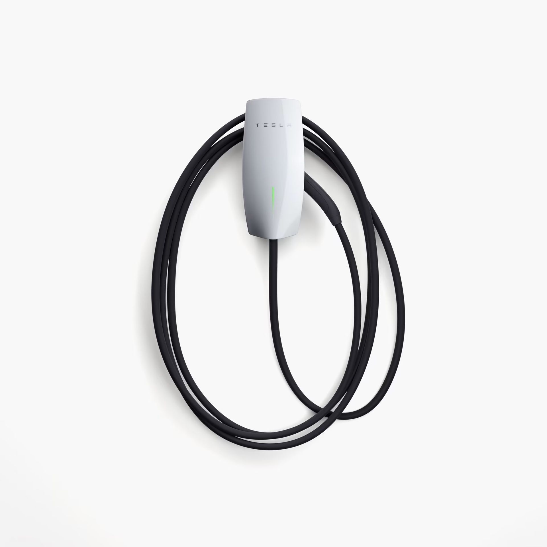White Tesla Wall Connector with black cable, mounted on a white wall.