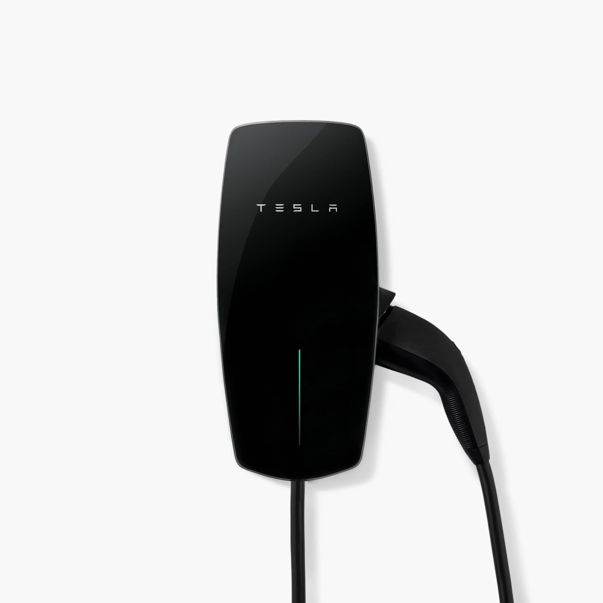 Black Tesla Wall Connector mounted on a white wall, charging cable attached.