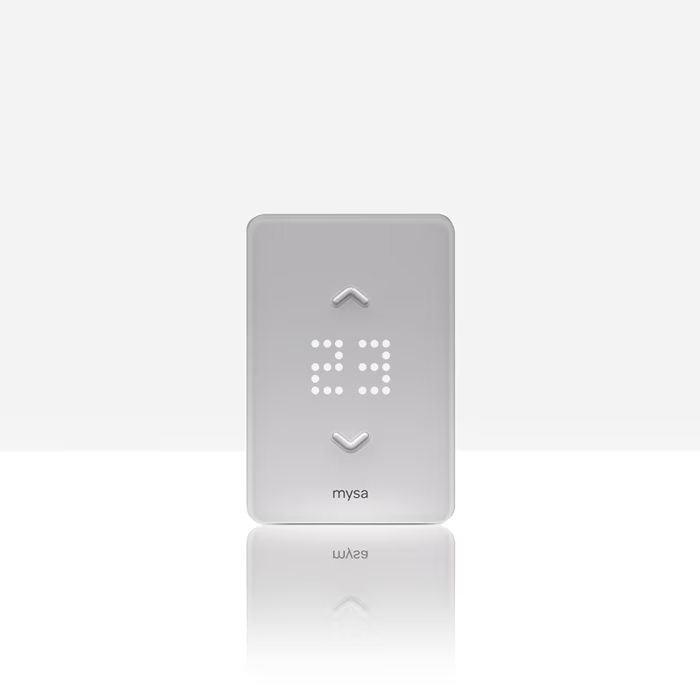 White thermostat with digital display showing