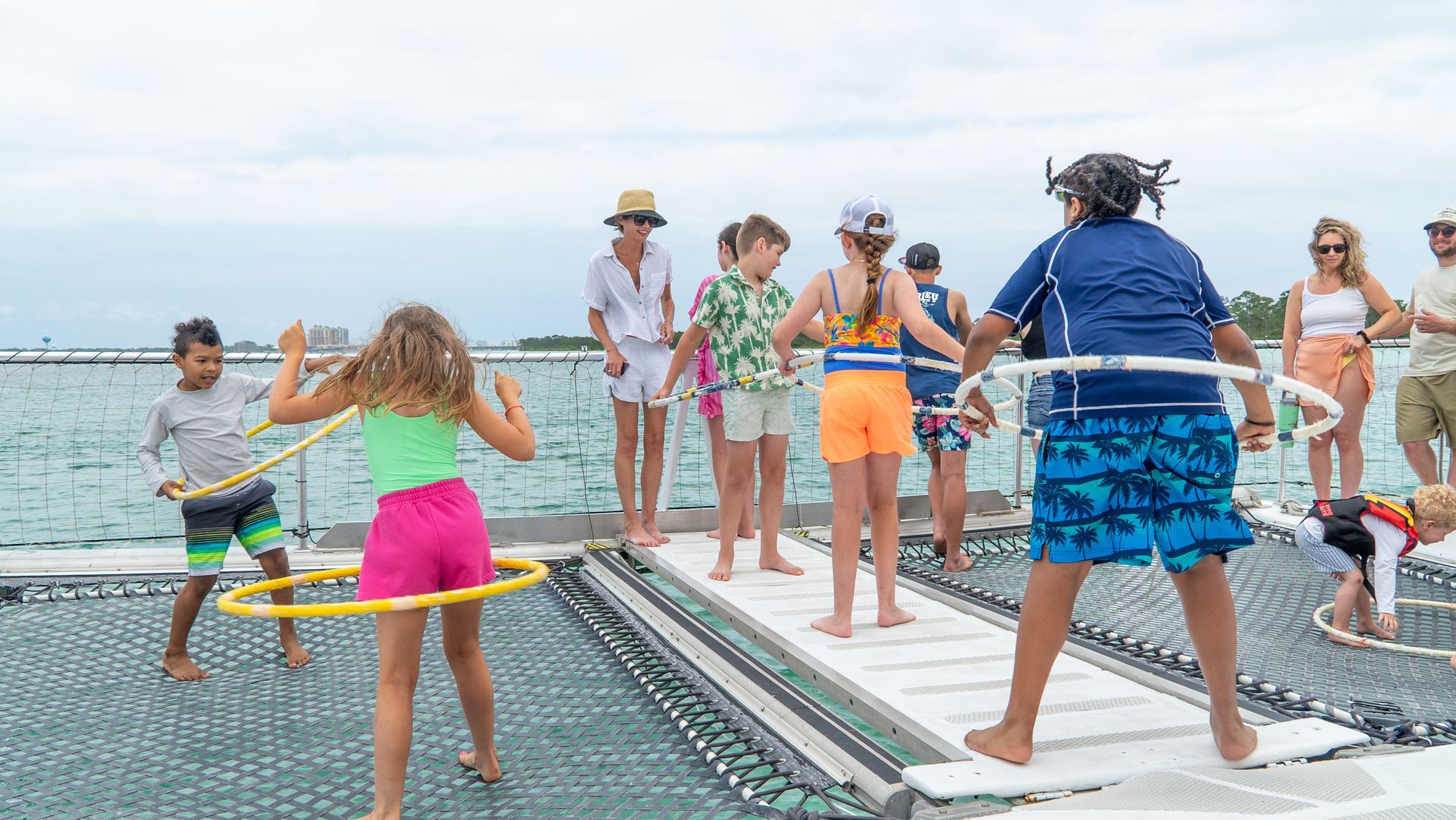 Kids hoola hooping on Dolphin Cruise
