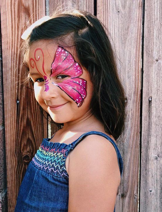 Pink butterfly face painting on a girl