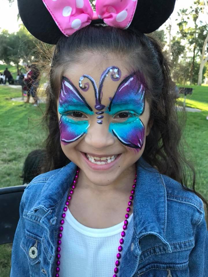 Purple and blue glitter butterfly face painting