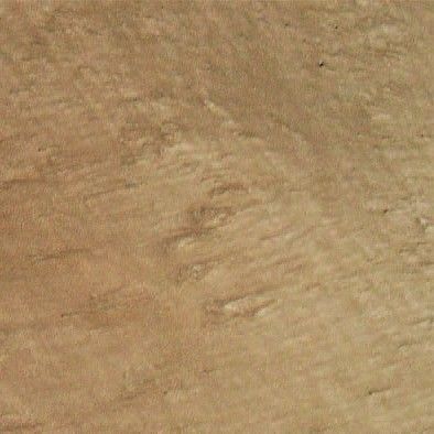 Close-up of textured tan sand with rippled patterns