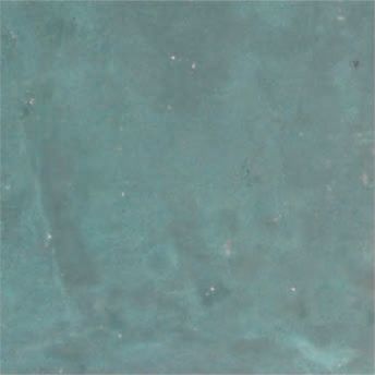 Close-up of a mottled blue-green textured surface with faint spots and marks
