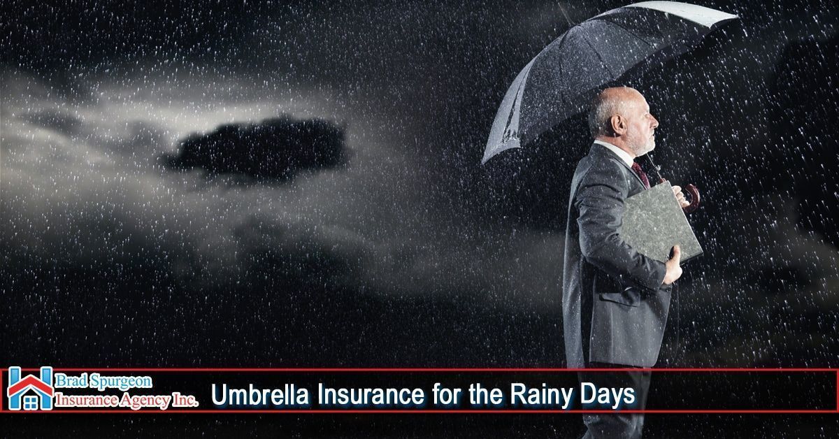 A person in a suit holds an umbrella under heavy rain