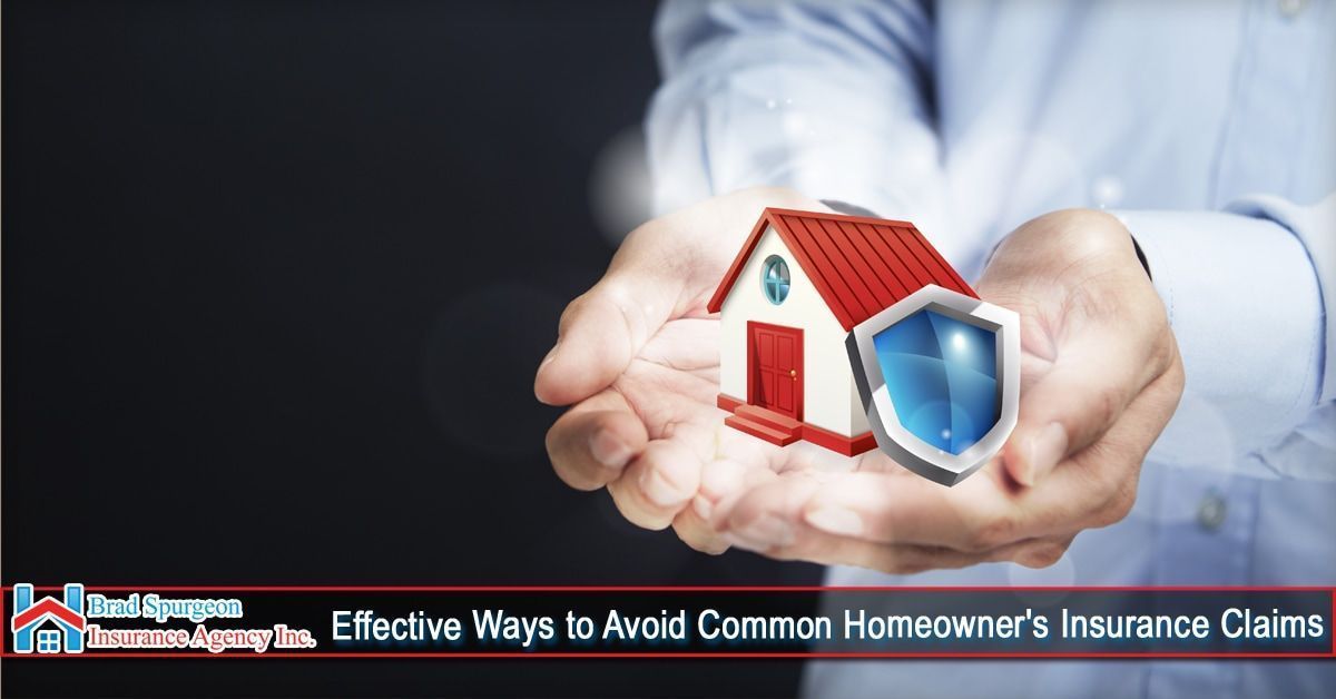Hands hold a small model house with a blue protective shield, symbolizing home insurance