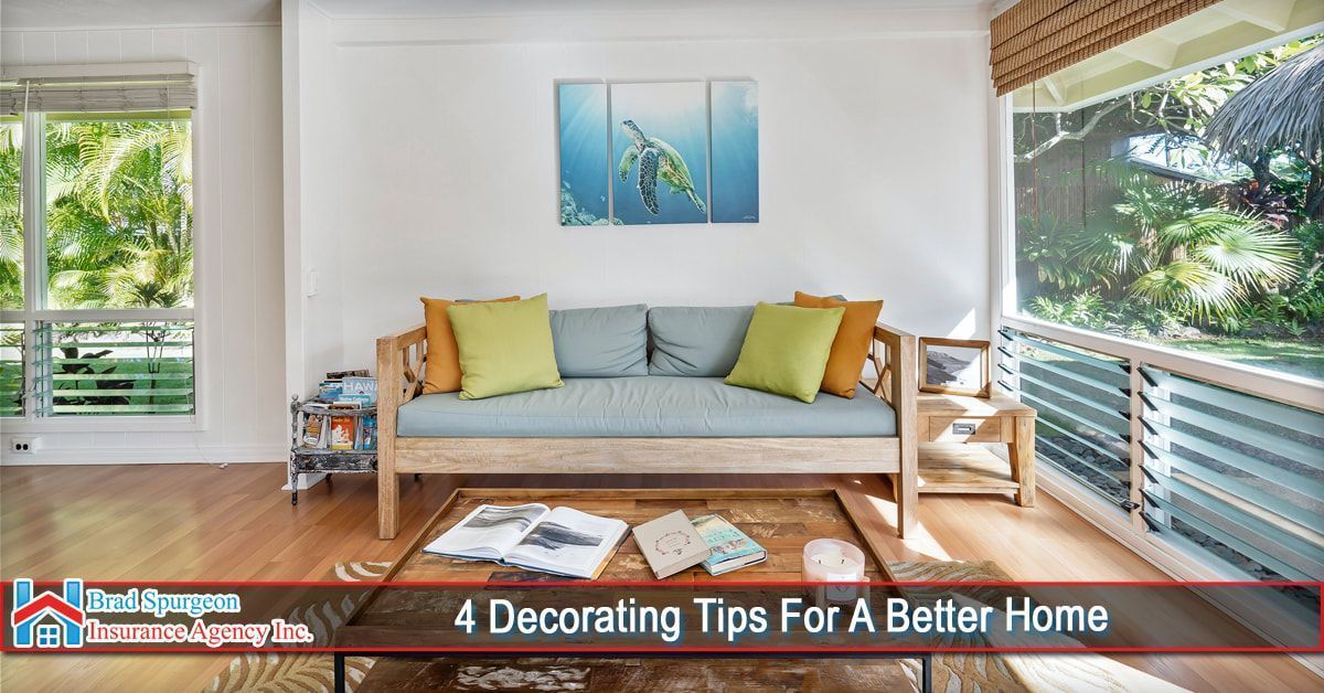 A brightly lit living room featuring a wooden daybed with lime green and blue cushions, a low table, and large windows.