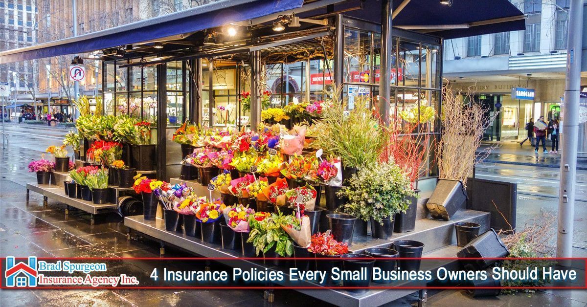 An outdoor flower kiosk on a city street at dusk