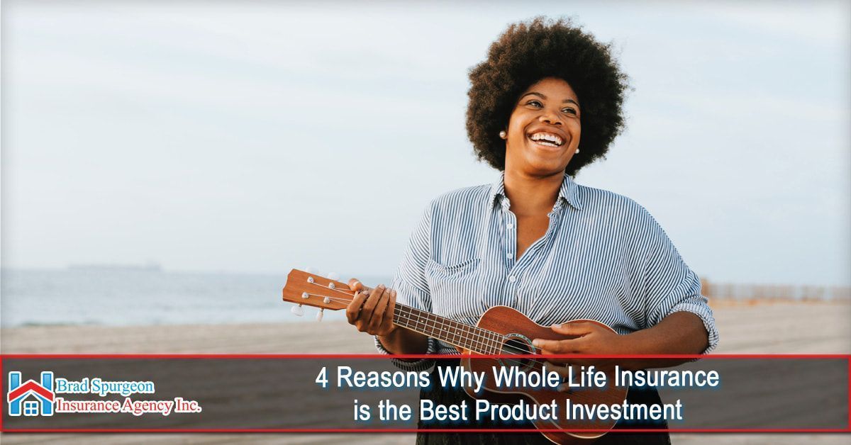 A person smiles while playing a ukulele on a beach