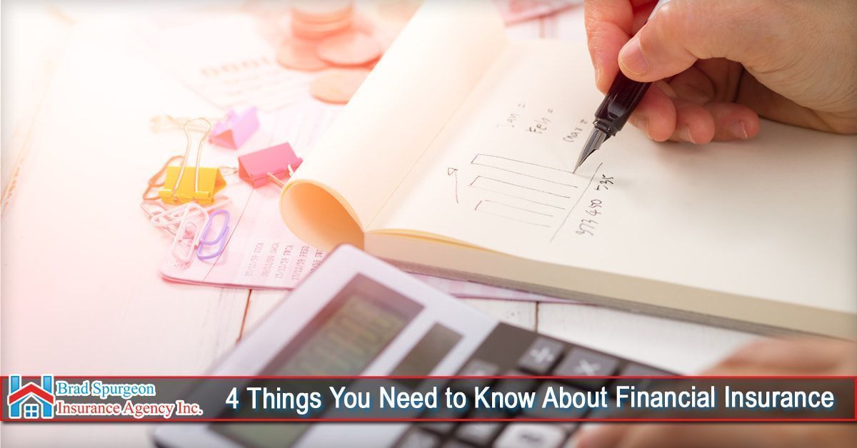 A person writes in a notebook near a calculator and colorful paper clips