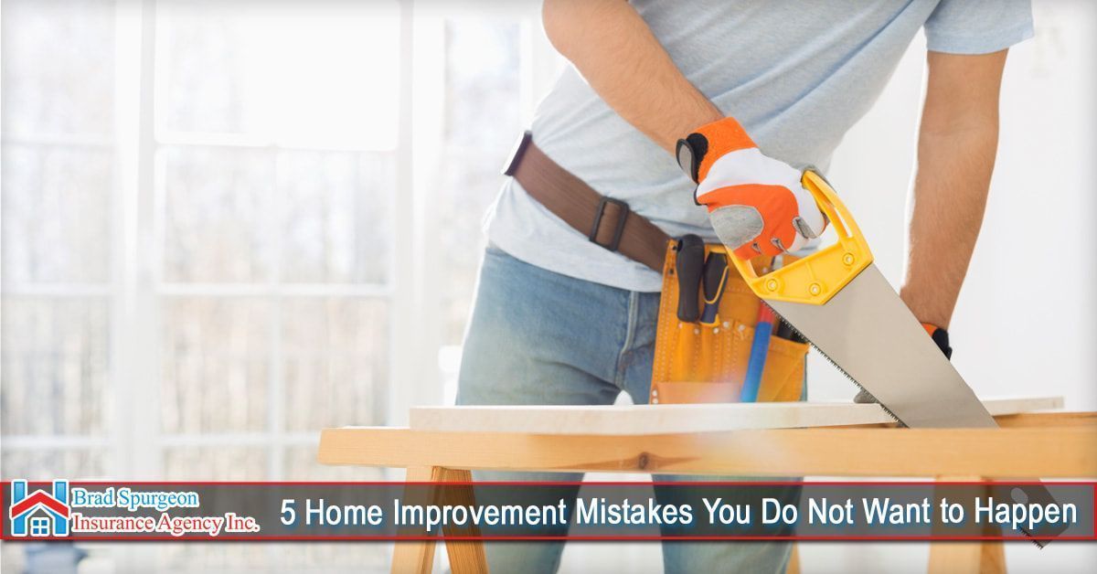 A person wearing work gloves saws a wooden board on a workbench