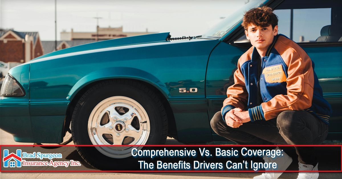 A person crouching beside a teal vintage Ford Mustang with a 