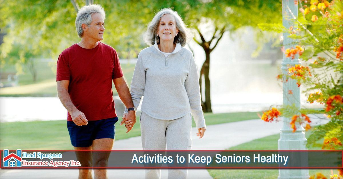 Two people holding hands while walking on a path in a park