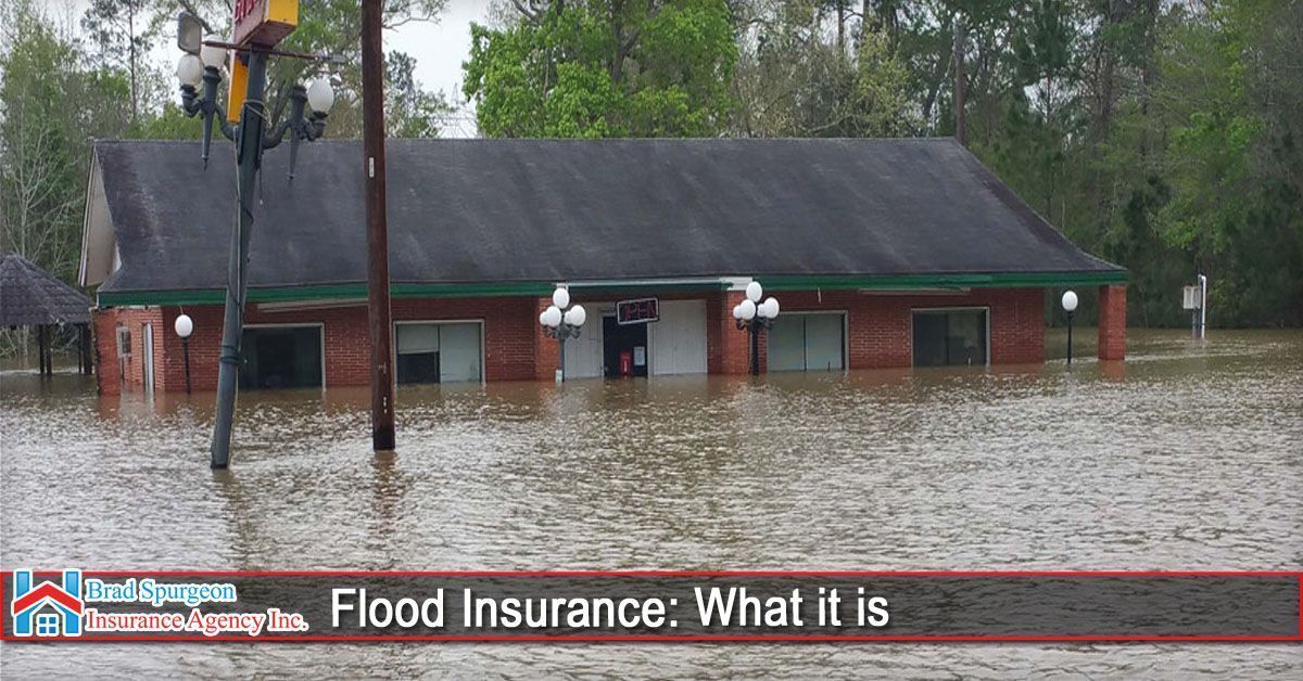 A brick building partially submerged in floodwaters