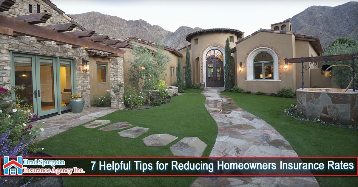 A luxury home with stone accents and a manicured lawn