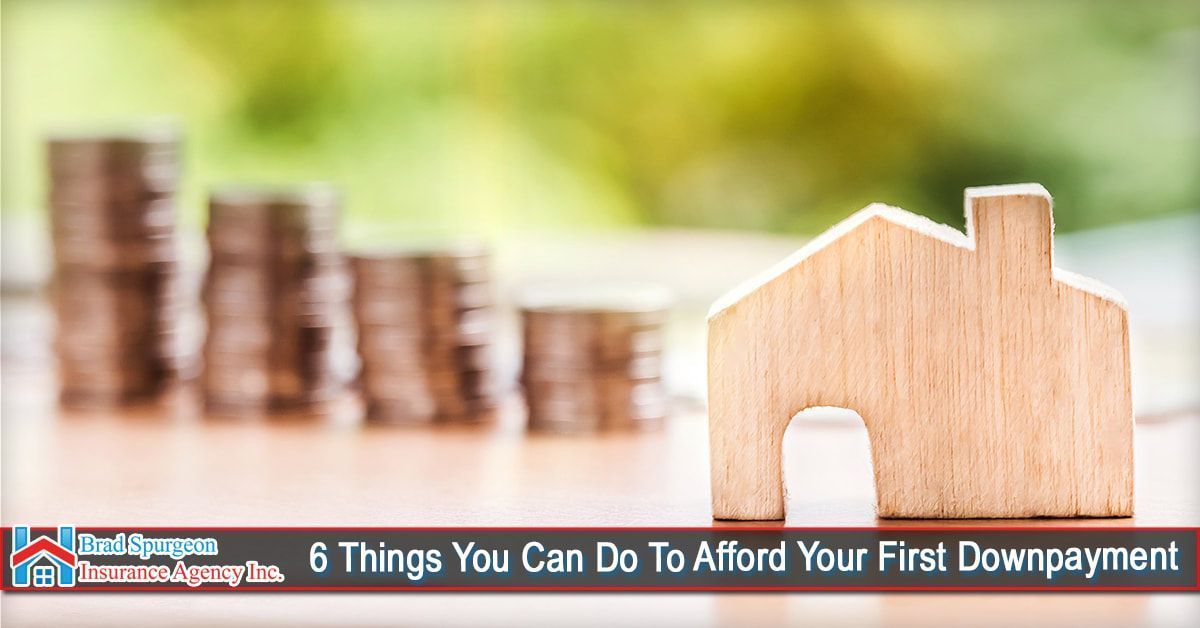 Stacks of coins next to a small wooden house cutout